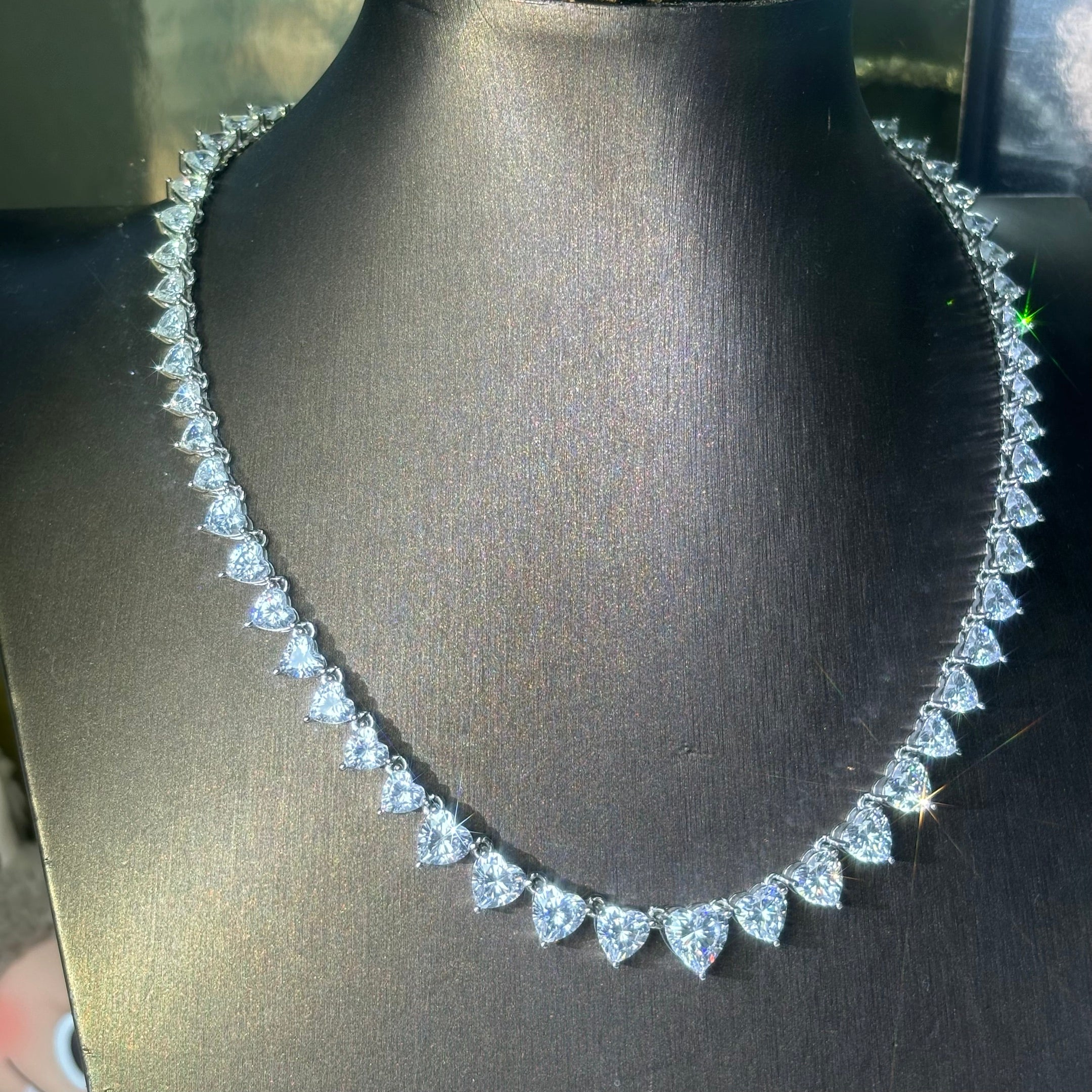 A collection of tennis necklaces with various cut gemstones